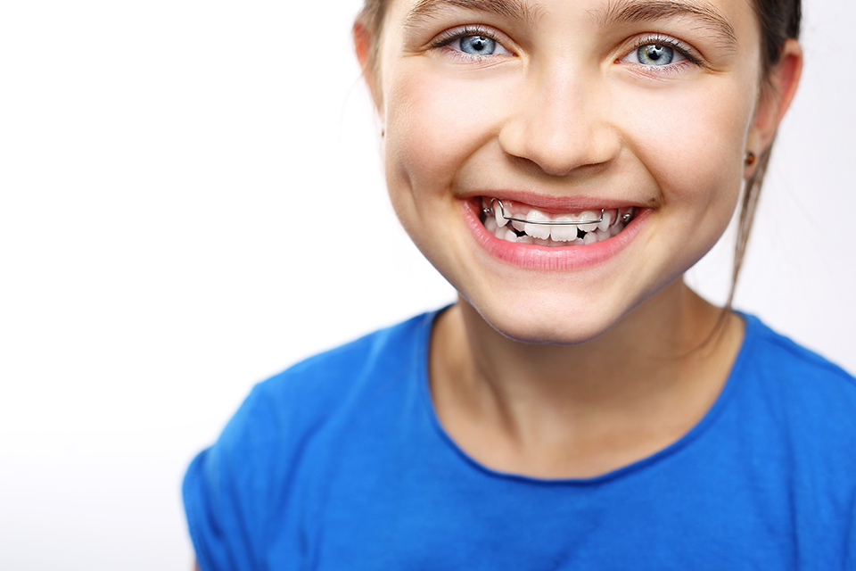 a child with retainer smiling for the camera